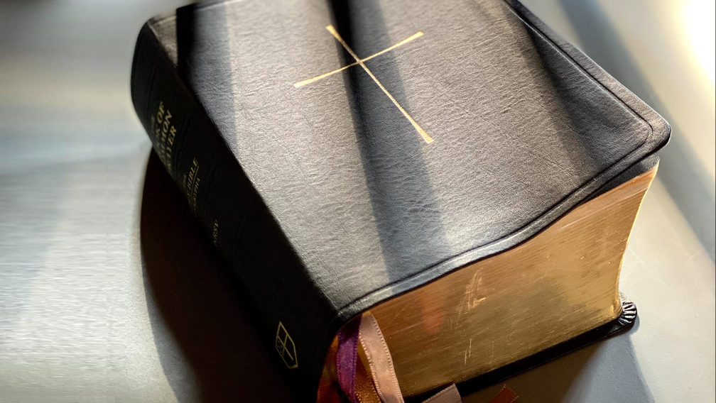 Rays of sunlight across a leather-bound copy of The Book of Common Prayer