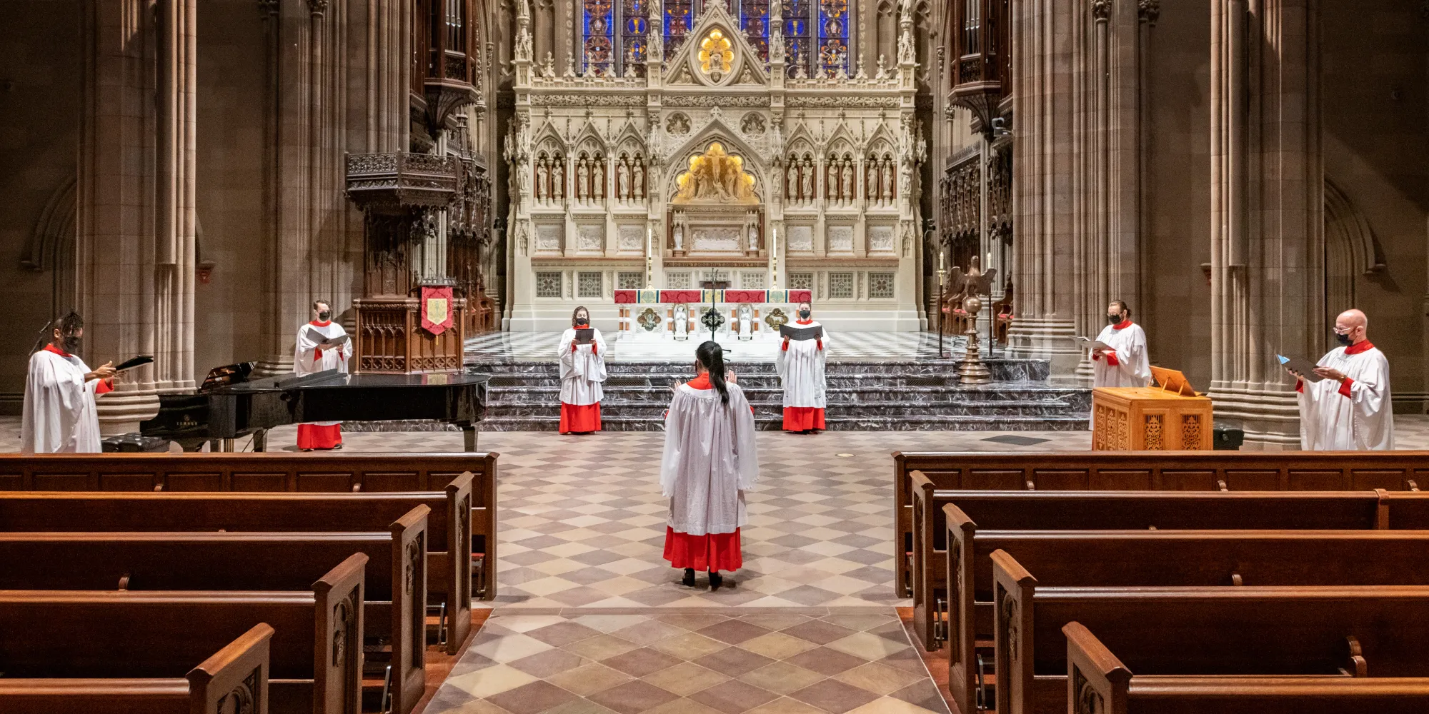 Members of the Choir of Trinity Wall Street socially distance while singing at Trinity Church during the COVID-19 pandemic