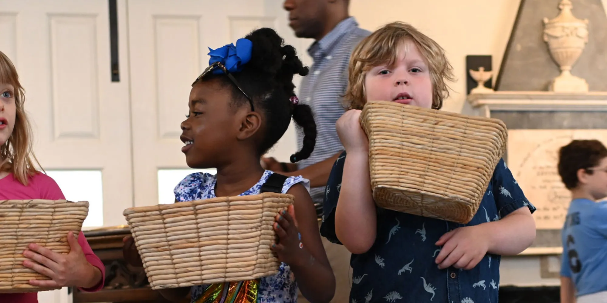 Children distribute bulletins at a Family Service