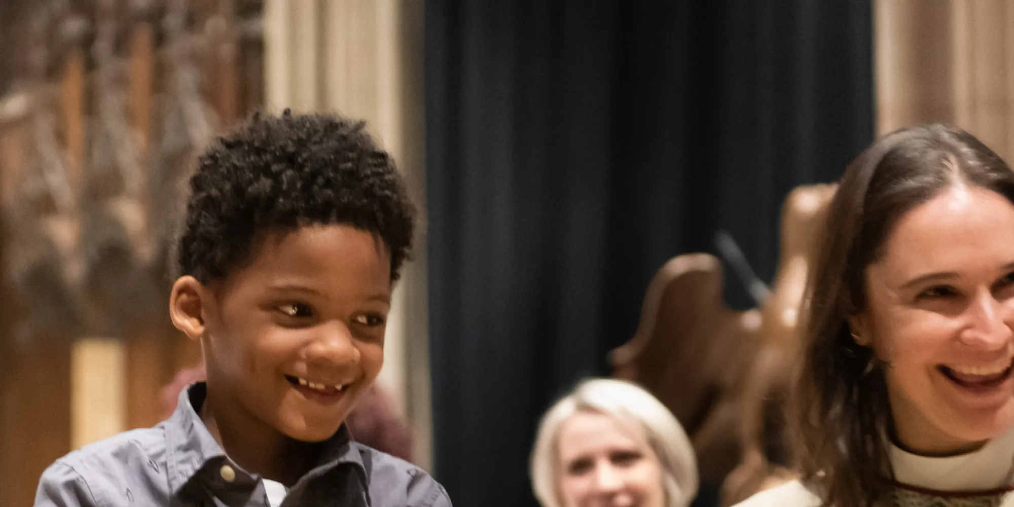 Family smiles at one another in the chancel of Trinity Church with the Rev.Kristin Kaulbach Miles, Regina Jacobs, and the Rev. Dr. Mark Bozzuti-Jones