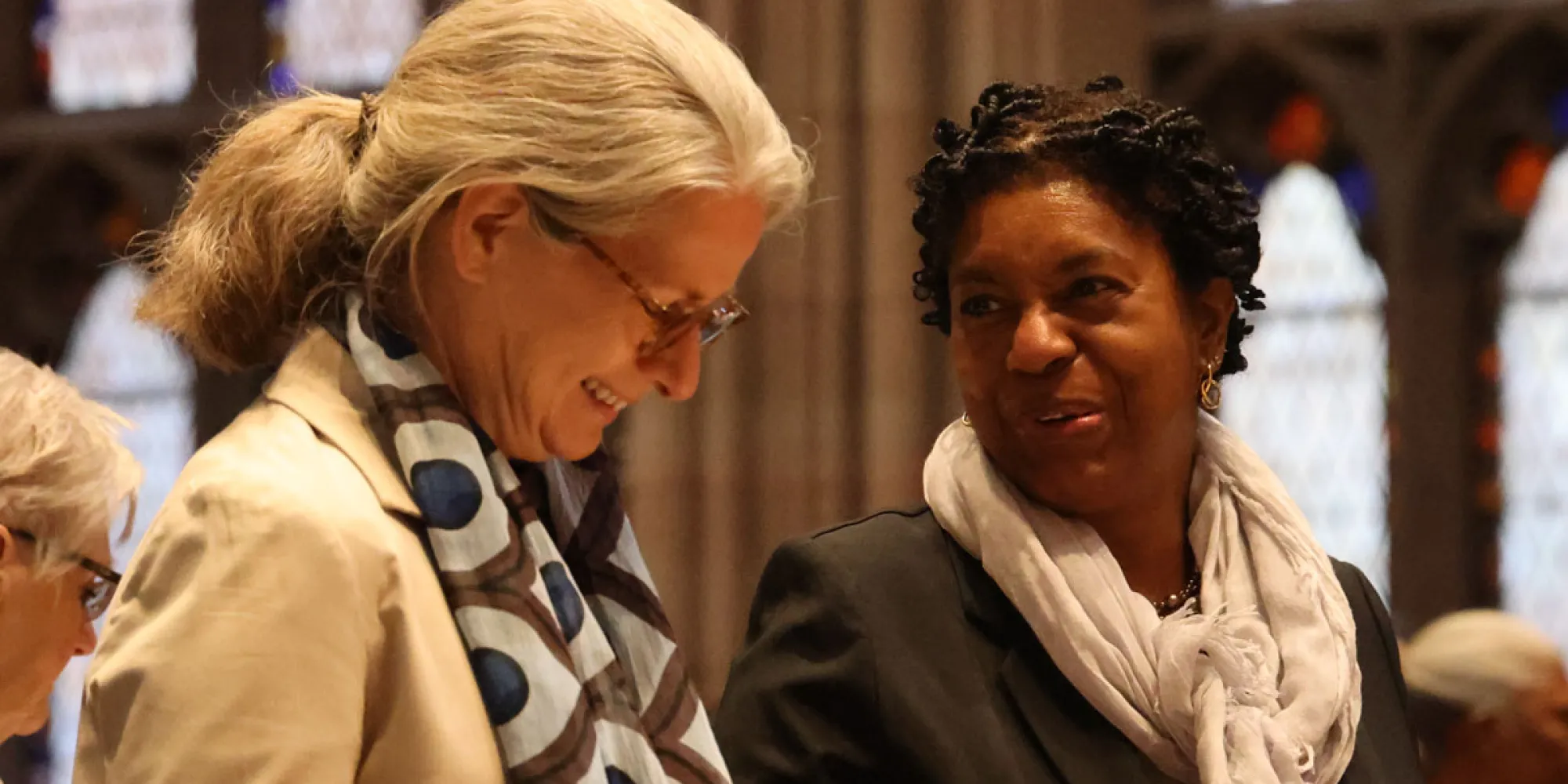 Two council members talk after a service in Trinity Church.