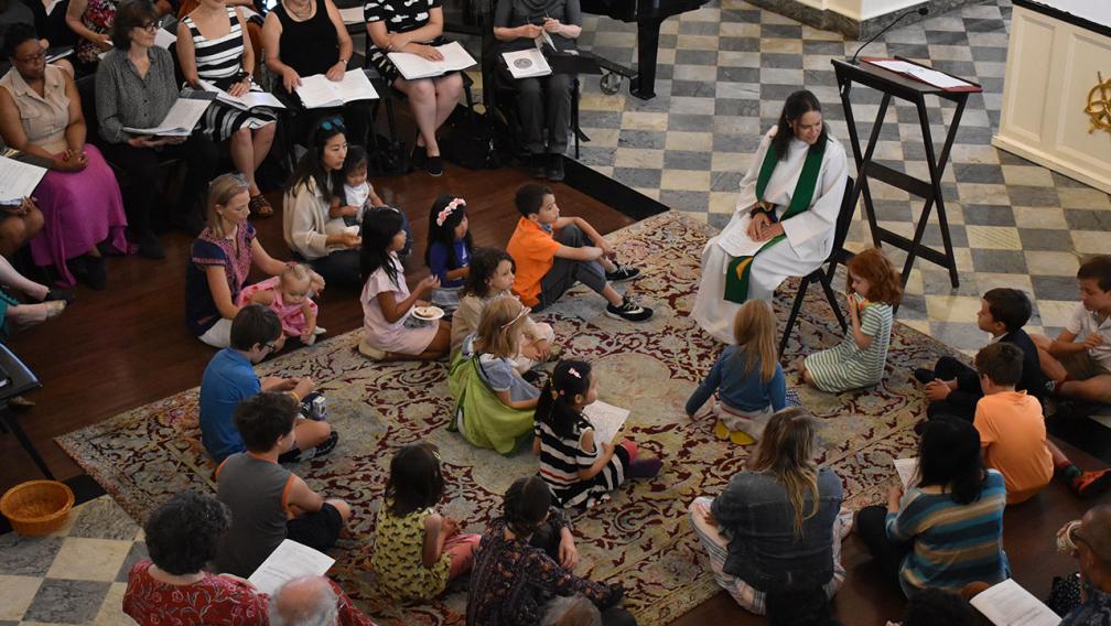 Mother Kristin sits teaching children in St. Paul's Chapel