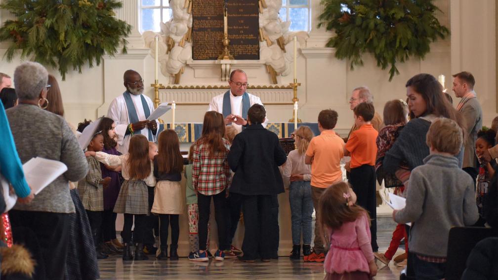 Children gather around the altar in St. Paul's Chapel