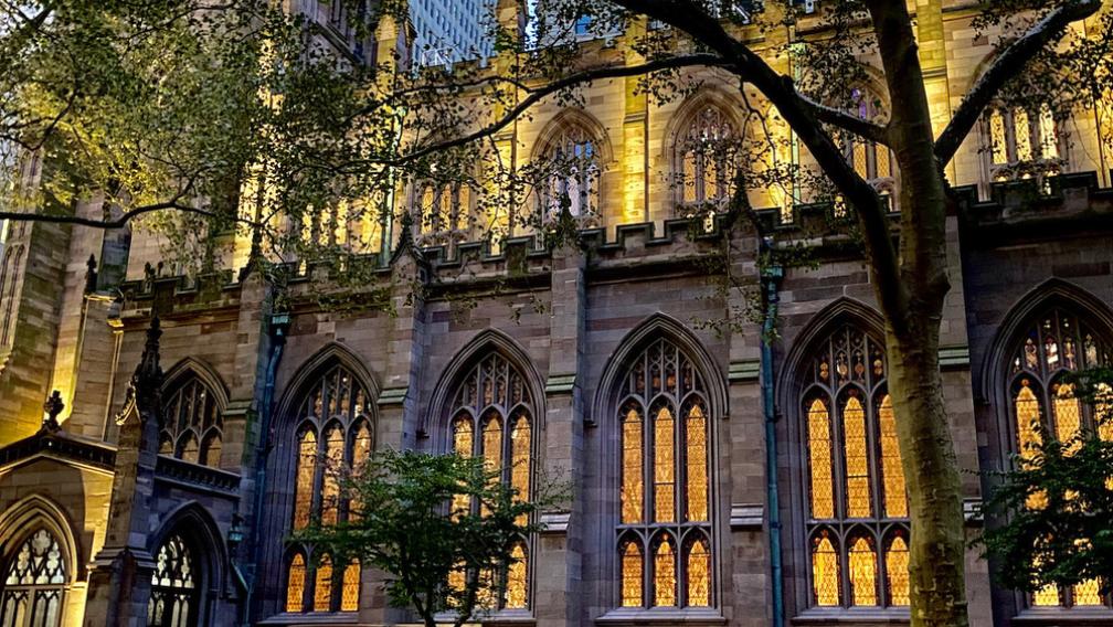Trinity Church exterior lit up in orange and yellow