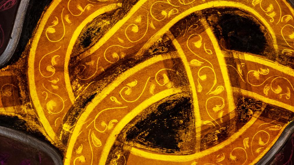 Detail photo of stained glass depicting a golden knot in Trinity Church