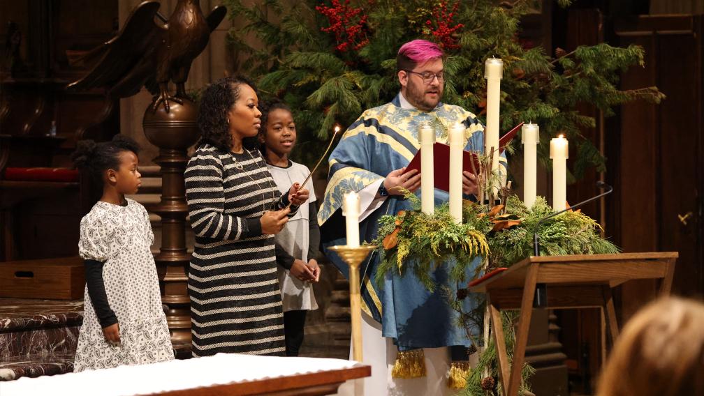 A family lights the Advent wreath during the 9am service in Trinity Church