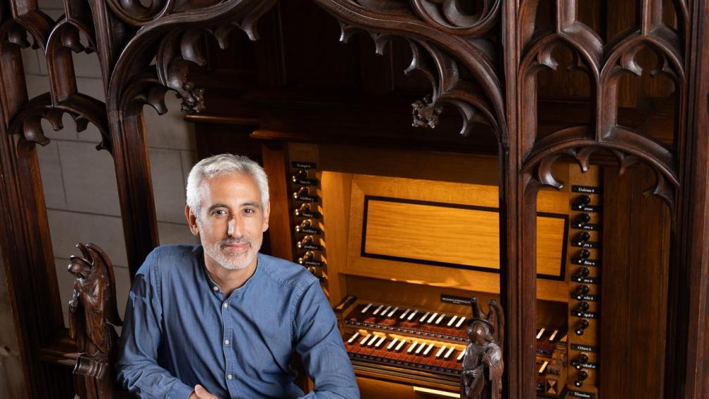 Avi Stein poses at the Chapel of All Saints organ.