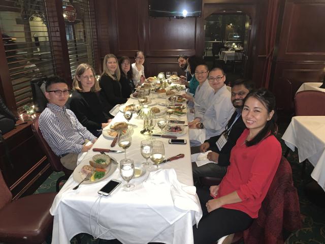 2019-2020 Trinity Union Fellows sit at table enjoying their dinner.