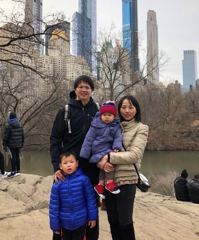 The Wu Family of four faces the camera, standing in Central Park.