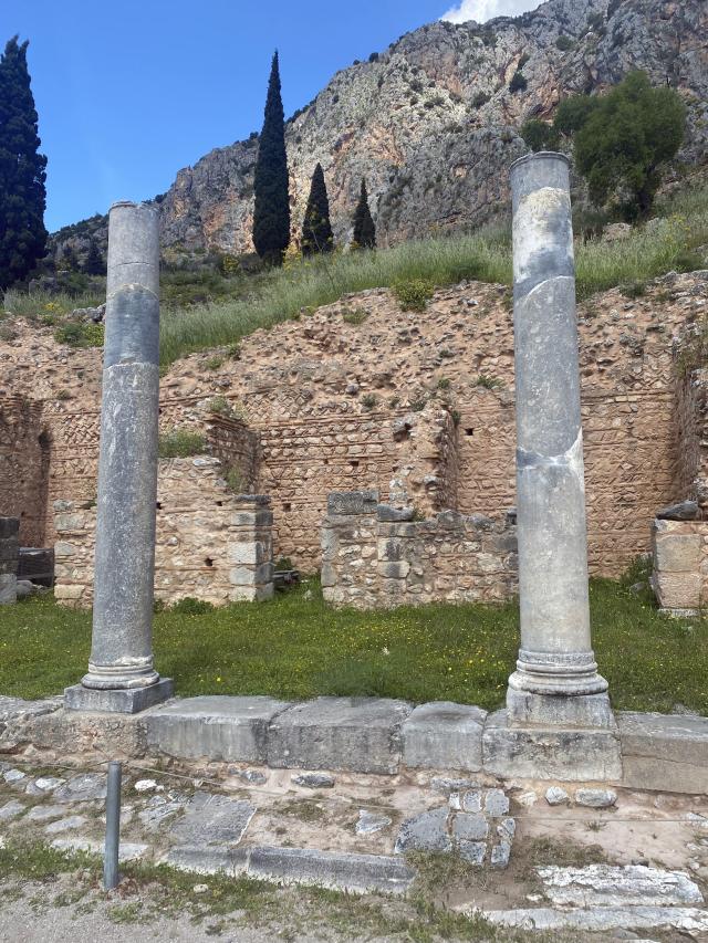 Two columns stand among ruins