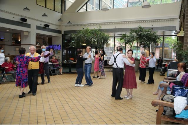 Seniors practicing ballroom dancing in the atrium space