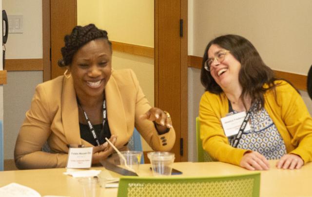 Fellows Folake Oni and Jessica Frederick share a laugh during the Community Organizing course at the Trinity Commons.