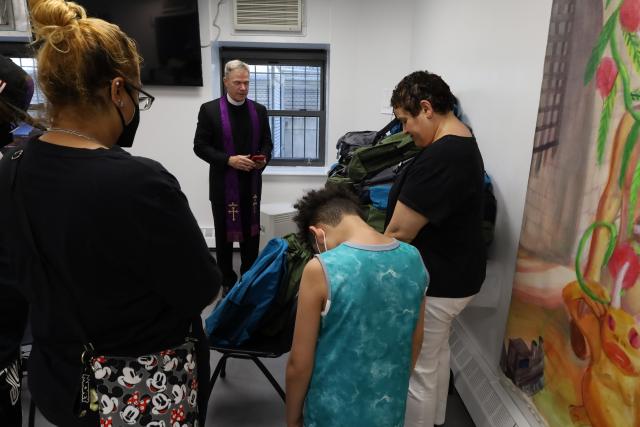 The Rev. Michael Bird blesses backpacks at The Loisaida Center on September 6, 2023