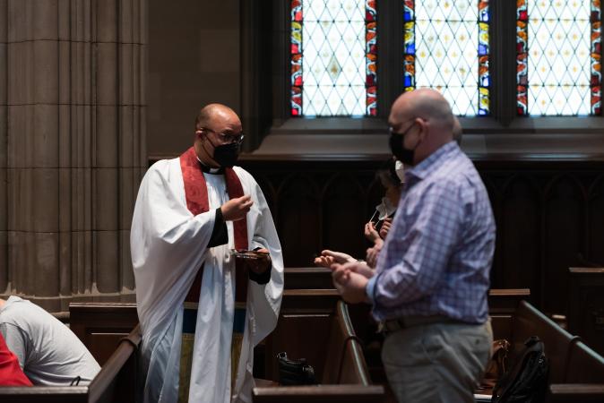 The Rev. Phil Jackson distributes Holy Communion May 23, 2021