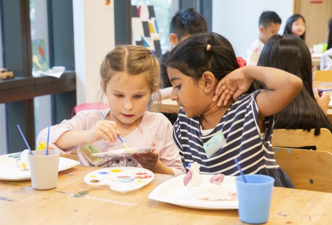 Two girls paint sculptures in the Trinity Commons art studio