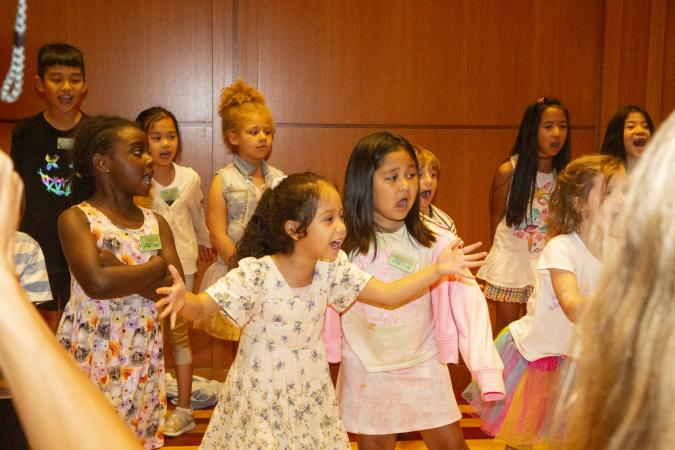 Children perform a song during the Trinity Summer Program