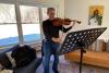Guest plays violin during a Rest and Renewal Retreat