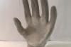 A sculpted gray hand