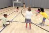 Children play in the Trinity Commons gym during the 2023 Summer Program