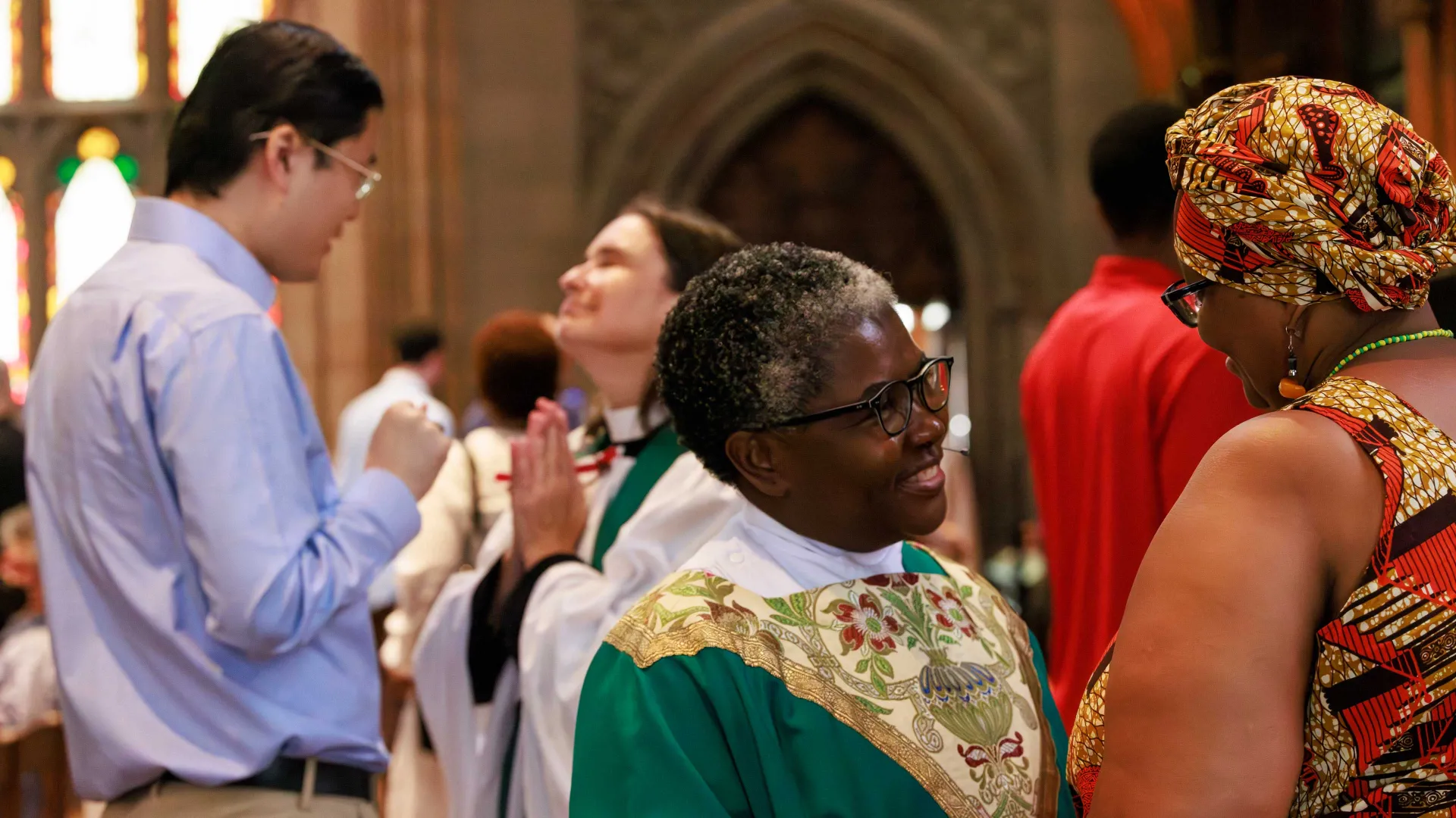 Priests and parishioners catch up after a Sunday service at Trinity Church.