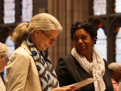 Two council members talk after a service in Trinity Church.