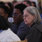 Sister Ann Whittaker and others watch Trinity Institute speakers.