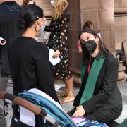 The Rev. Kristin Kaulbach Miles meets with parishioner in masks