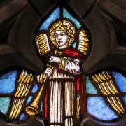 A stained glass window depicting an angel with a trumpet in the Chapel of All Saints in Trinity Church