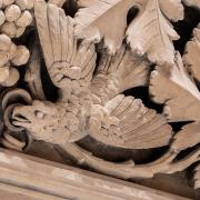 Detail photo of plaster work depicting a bird and foliage in Trinity Church