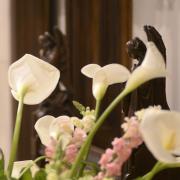 Easter lilies in Trinity Church in front of carved wooden angels
