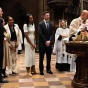 The Rev. Phil Jackson performs a baptism on All Saints' Sunday