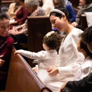 A family with a small child in the pews of Trinity Church