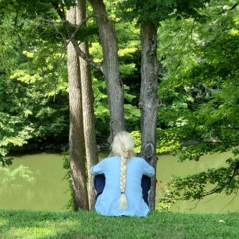 Woman with a braided ponytail overlooks the bank of the Housatonic River