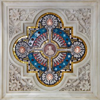 Close-up square image of blue and yellow mosaic in the altar with Jesus and four circles around him.