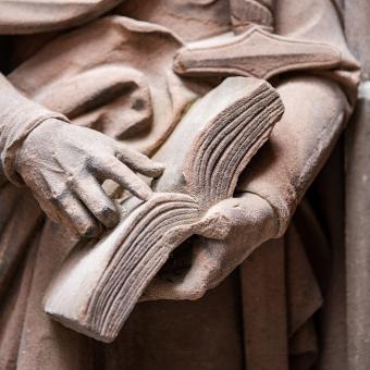 Statue holding a book