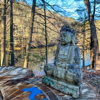 Buddha statue by lake