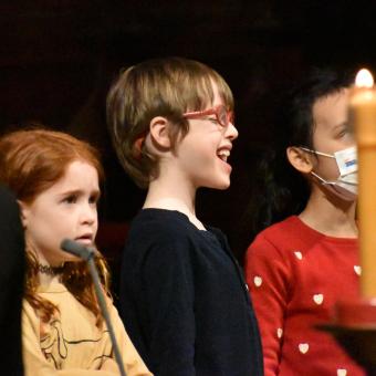 A smiling and singing child during the 9am service at Trinity Church