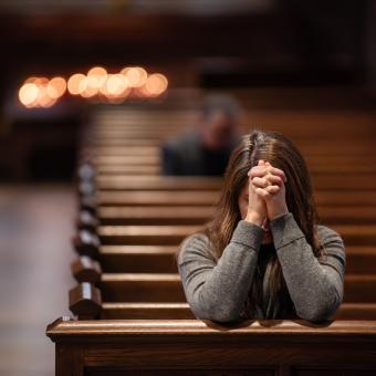 A parishioner bows in prayer in Trinity Church