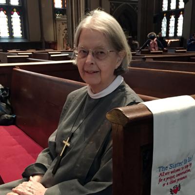 Sister Ann Whittaker sits in a pew at Trinity Church