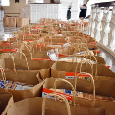 Rows of brown bags filled with food and pamphlets line St. Paul's Chapel.