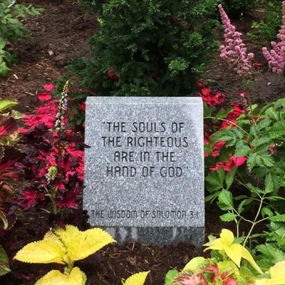 A garden marker that reads: "The souls of the righteous are in the hand of God."-The Wisdom of Solomon 3:1