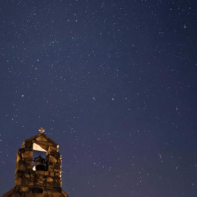 Chapel bell under a starry sky