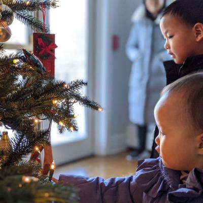 Entranced by its lights, children reach out to touch ornaments on the retreat center's Christmas tree