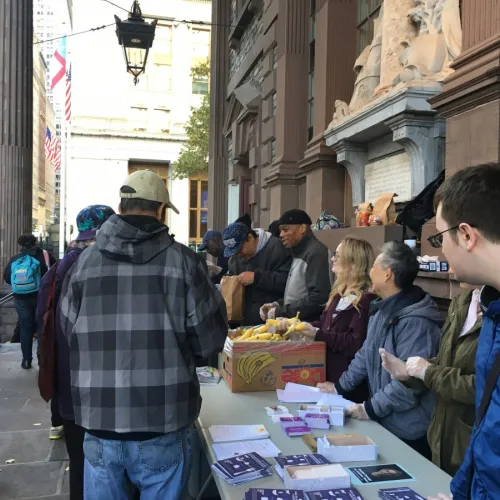 People lining up to get brown bags.