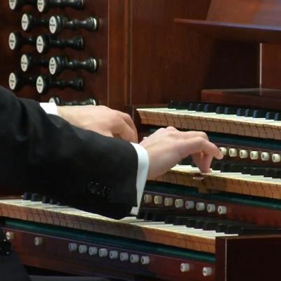 Close up of Organist Nathan Laube's hands playing the organ