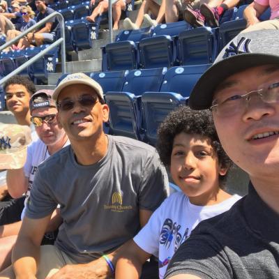 Men and boys from the group, Trinity Men, take a selfie from the stands of Yankee Stadium