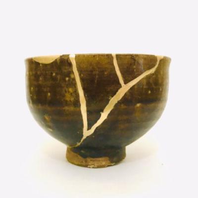 Broken ceramic bowl mended with gold