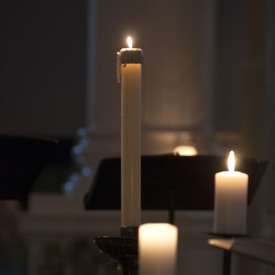 Candles glow in the darkness in St. Paul's Chapel