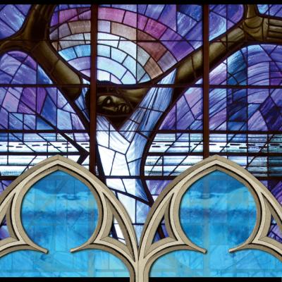 Stained glass image of man with arms outstretched