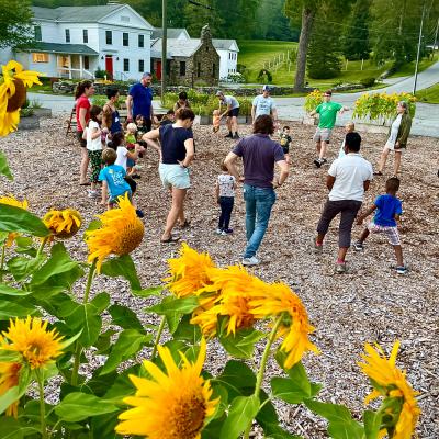 Families playing in a sunflower garden